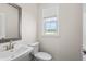 Simple, clean bathroom with pedestal sink and mirror at 3808 Thatcher Sw Dr, Marietta, GA 30008