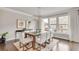 Elegant dining room with a large wooden table and six white chairs at 3808 Thatcher Sw Dr, Marietta, GA 30008