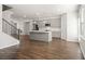 Open kitchen with gray cabinets, island, and hardwood floors at 3808 Thatcher Sw Dr, Marietta, GA 30008