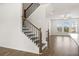 Modern staircase with dark wood and metal railing at 3808 Thatcher Sw Dr, Marietta, GA 30008