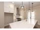 Modern kitchen with white cabinetry, island, stainless steel appliances, and stylish lighting at 540 Fisher Dr # 46, Alpharetta, GA 30009