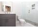 Modern bathroom with gray vanity, white toilet, and a glass shower enclosure at 540 Fisher Dr # 46, Alpharetta, GA 30009