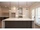 Modern kitchen with white cabinets, quartz countertops, and a large island at 550 Fisher Dr # 46, Alpharetta, GA 30009