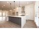 Modern kitchen with white and gray cabinets and a large island at 550 Fisher Dr # 46, Alpharetta, GA 30009