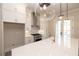 Modern kitchen with white cabinets, quartz countertops and island at 550 Fisher Dr # 46, Alpharetta, GA 30009