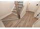 Modern staircase with gray wood-look floors and black railing at 550 Fisher Dr # 46, Alpharetta, GA 30009