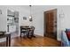 View of dining area next to the kitchen with stylish lighting, hardwood floors, and an exposed-brick wall at 708 Argonne Ne Ave # 5, Atlanta, GA 30308