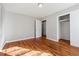 Bedroom with hardwood floors, neutral walls, and ample closet space at 8554 Taylor Rd, Riverdale, GA 30274