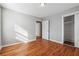 Well-lit bedroom featuring hardwood floors and built-in closet at 8554 Taylor Rd, Riverdale, GA 30274