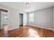 Bedroom featuring hardwood floors, neutral walls, and a large closet at 8554 Taylor Rd, Riverdale, GA 30274