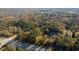 Aerial view of home nestled in wooded area near a roadway at 200 Mcguirts Bridge Rd, Covington, GA 30014