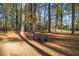 Backyard bench offers place for repose amongst beautiful trees and fallen leaves at 200 Mcguirts Bridge Rd, Covington, GA 30014