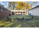 Landscaped backyard with a stone retaining wall and steps at 200 Mcguirts Bridge Rd, Covington, GA 30014