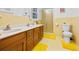 Bathroom with double vanity, shower, and yellow tile at 200 Mcguirts Bridge Rd, Covington, GA 30014