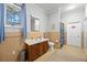 Bathroom with beige tile, shower, and updated vanity at 200 Mcguirts Bridge Rd, Covington, GA 30014