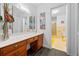 Vintage bathroom featuring wood vanity with drawers, a large mirror, and a view of the shower at 200 Mcguirts Bridge Rd, Covington, GA 30014