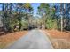 Long driveway leading to a gated entrance with brick pillars at 200 Mcguirts Bridge Rd, Covington, GA 30014