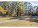 Long, winding driveway leading to a charming home nestled among trees at 200 Mcguirts Bridge Rd, Covington, GA 30014