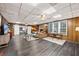 Spacious living room with wood paneled walls, a brick fireplace, and luxury vinyl flooring at 200 Mcguirts Bridge Rd, Covington, GA 30014