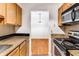 Galley kitchen with granite countertops and view into dining area at 2955 Seven Pines Ln # 203, Atlanta, GA 30339