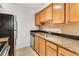 Well-equipped kitchen featuring granite countertops and wood cabinets at 2955 Seven Pines Ln # 203, Atlanta, GA 30339