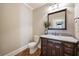 Simple powder room with granite countertop and dark wood vanity at 3327 High Noontide Way, Acworth, GA 30101