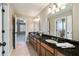 Double vanity bathroom with dark granite and tile floors at 3327 High Noontide Way, Acworth, GA 30101