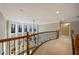 Open second floor hallway with curved railing and natural light at 3327 High Noontide Way, Acworth, GA 30101