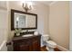 Elegant powder room with dark vanity and granite countertop at 3327 High Noontide Way, Acworth, GA 30101