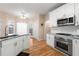 Modern kitchen with white cabinets, granite counters, and island at 3853 Cohutta Pass, Marietta, GA 30062