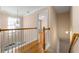 Upstairs hallway with hardwood floors and access to bedrooms at 3853 Cohutta Pass, Marietta, GA 30062