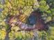 Single-story house surrounded by trees and a gravel driveway at 410 N Carroll N St, Bowdon, GA 30108