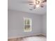 Bedroom with ceiling fan and large window at 410 N Carroll N St, Bowdon, GA 30108