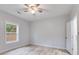 Bright bedroom with a ceiling fan and wood-look flooring and a window view at 410 N Carroll N St, Bowdon, GA 30108