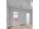 Bright bedroom with a ceiling fan, wood-look flooring, a walk-in closet, and a bathroom at 410 N Carroll N St, Bowdon, GA 30108