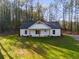 Lovely home has a well-kept lawn and a gravel driveway at 410 N Carroll N St, Bowdon, GA 30108