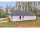 White house with covered porch and gravel driveway at 410 N Carroll N St, Bowdon, GA 30108