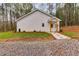 White house with stone walkway and landscaping at 410 N Carroll N St, Bowdon, GA 30108