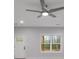 Bright living room with large windows and ceiling fan at 410 N Carroll N St, Bowdon, GA 30108