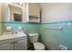 Clean bathroom with mint green tile and updated vanity at 8586 Taylor Rd, Riverdale, GA 30274