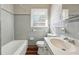 Clean bathroom with grey tile and a bathtub at 8586 Taylor Rd, Riverdale, GA 30274