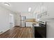 Bright kitchen with stainless steel appliances and wood-look floors at 8586 Taylor Rd, Riverdale, GA 30274