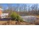 Backyard view of the lake, trees, and a storage shed at 1586 Highway 11 N, Social Circle, GA 30025