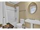 Clean bathroom with tub, toilet and pedestal sink at 1586 Highway 11 N, Social Circle, GA 30025