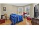 Bright bedroom with wood floors, large windows, and blue bedding at 1586 Highway 11 N, Social Circle, GA 30025