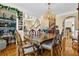 Elegant dining room features a large wood table, chandelier, and wine storage at 1586 Highway 11 N, Social Circle, GA 30025