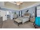 Spacious main bedroom with blue walls, a king-size bed, and sitting area at 1586 Highway 11 N, Social Circle, GA 30025