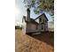 Unfinished house exterior, rear view, showcasing a chimney and yard at 2615 Virginia Cv, Riverdale, GA 30296