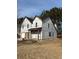 Two-story house under construction with grey roof and a covered porch at 2615 Virginia Cv, Riverdale, GA 30296