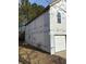 Unfinished house exterior with white siding and a single garage door at 2615 Virginia Cv, Riverdale, GA 30296